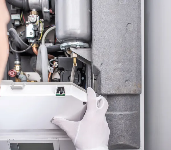 Central heating repair technician at work